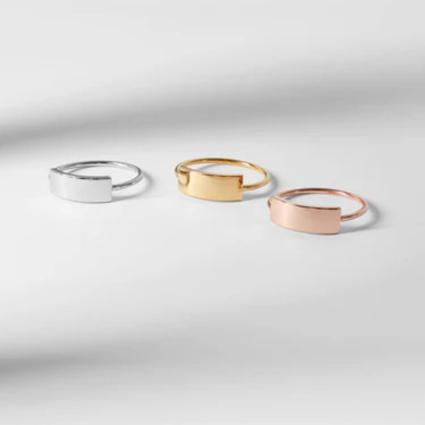 Three rings in silver, gold, and rose gold on a light gray background, Rose gold ring, statement ring, stainless steel, hypoallergenic, affordable jewelry, gift for her, engraveable, personalizable