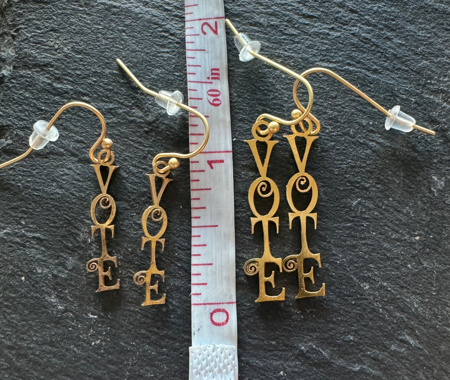 Vote Dangling Earrings Script Font next to ruler, two sizes
