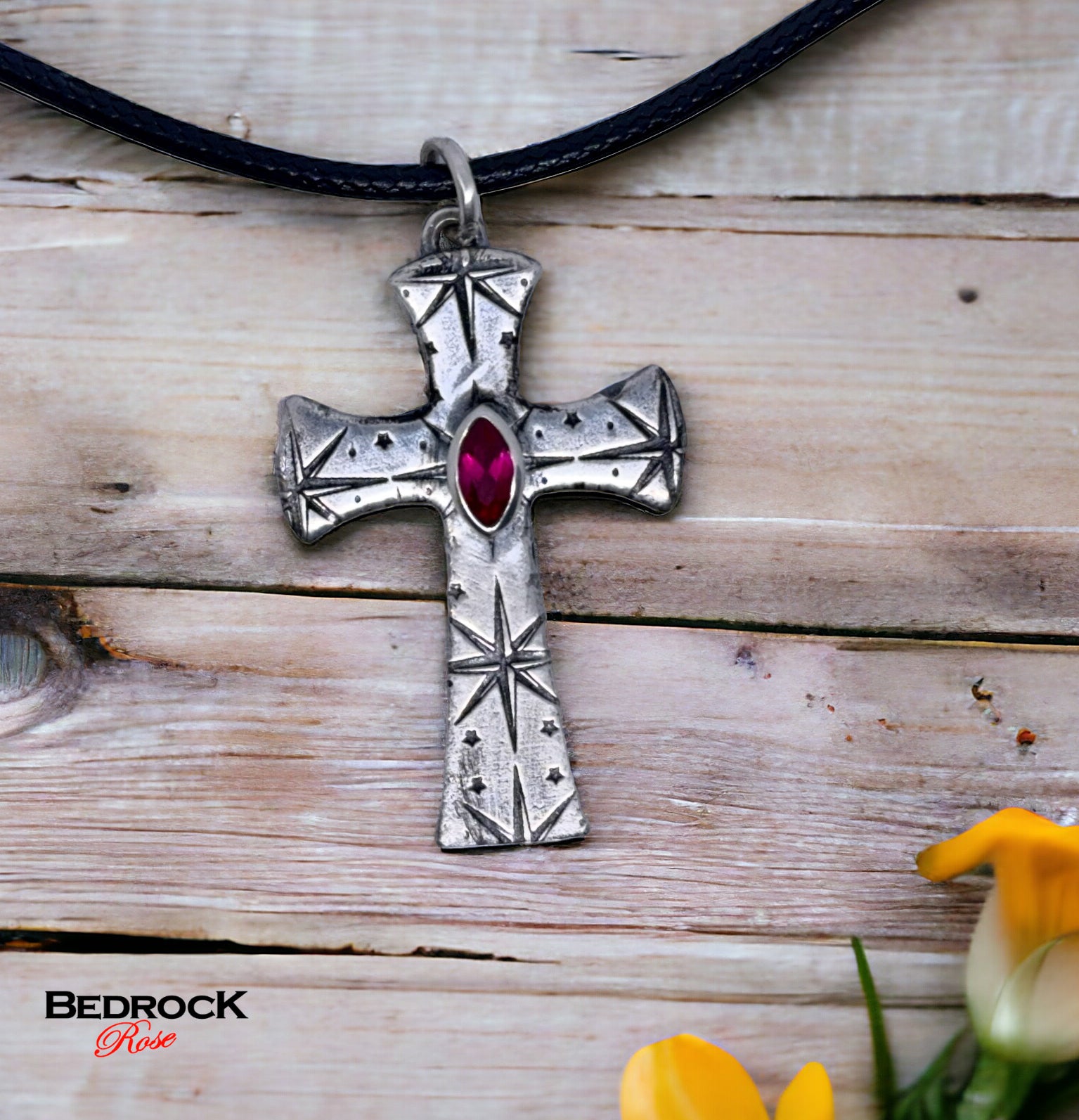 Front view of fine silver cross pendant with intricate pattern and ruby red marquise stone, handmade necklace