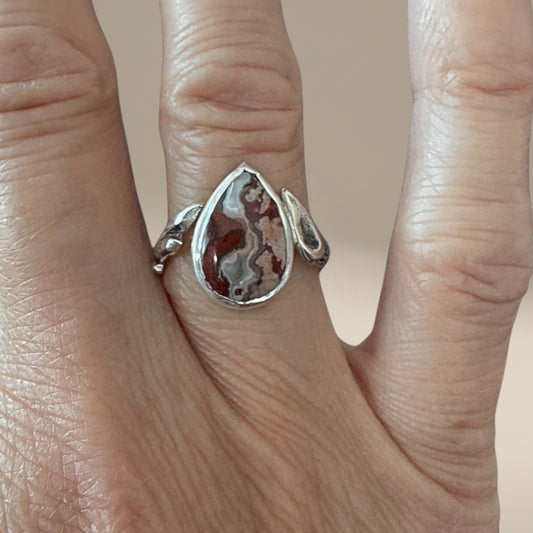 Bedrock Rose handcrafted sterling silver ring featuring a teardrop crazy lace agate stone with a branch-textured band.