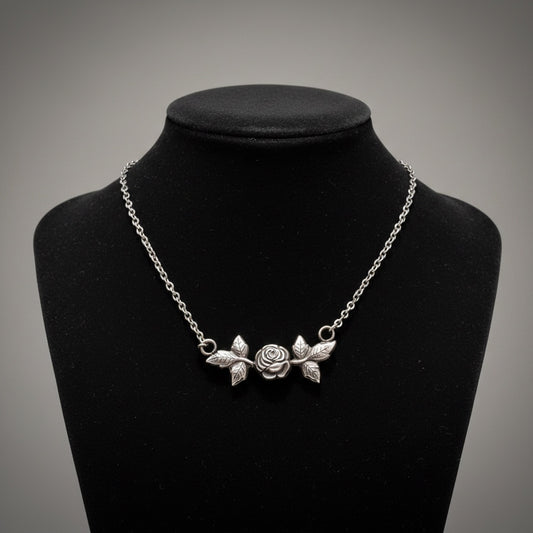 Bedrock Rose sterling silver necklace with rosebud and leaf pendant. Delicate floral design.