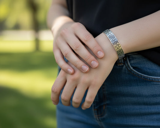 Bedrock Rose sterling silver-plated cuff bracelet with intricate floral monument flower pattern worn on a wrist