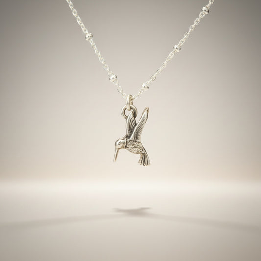 Bedrock Rose sterling silver hummingbird necklace with a delicate satellite chain. Perfect for nature lovers.