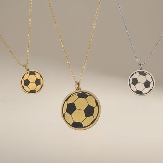 Bedrock Rose soccer ball pendant necklaces in brass and sterling silver with laser-engraved details on steel chains.