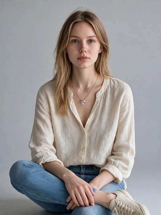 Bedrock Rose tri-leaf fine silver pendant worn by a woman in a beige linen shirt and blue jeans