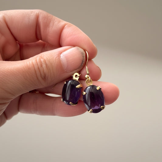 Bedrock Rose amethyst prong set oval drop earrings with gold-tone hooks.