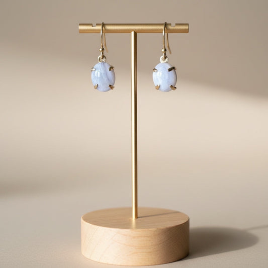 Bedrock Rose blue lace agate oval prong set dangle earrings with gold-tone hooks.