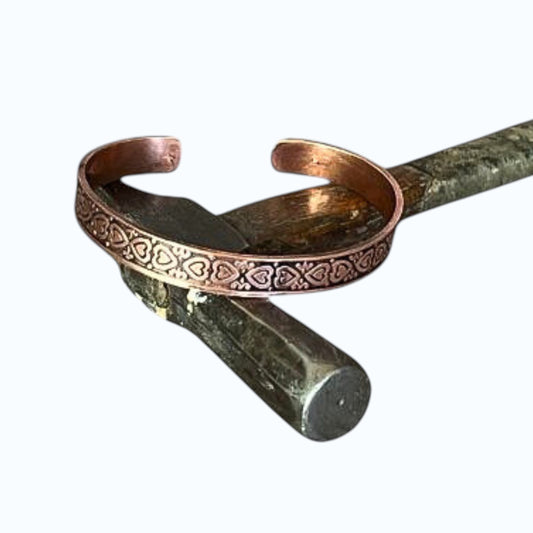Bedrock Rose copper cuff bracelet with antiqued finish and heart pattern design.