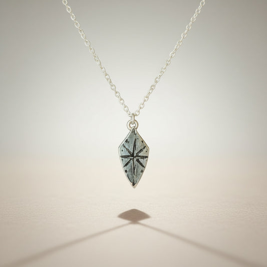 Bedrock Rose silver compass rose shield pendant necklace with a 16" sterling silver cable chain.