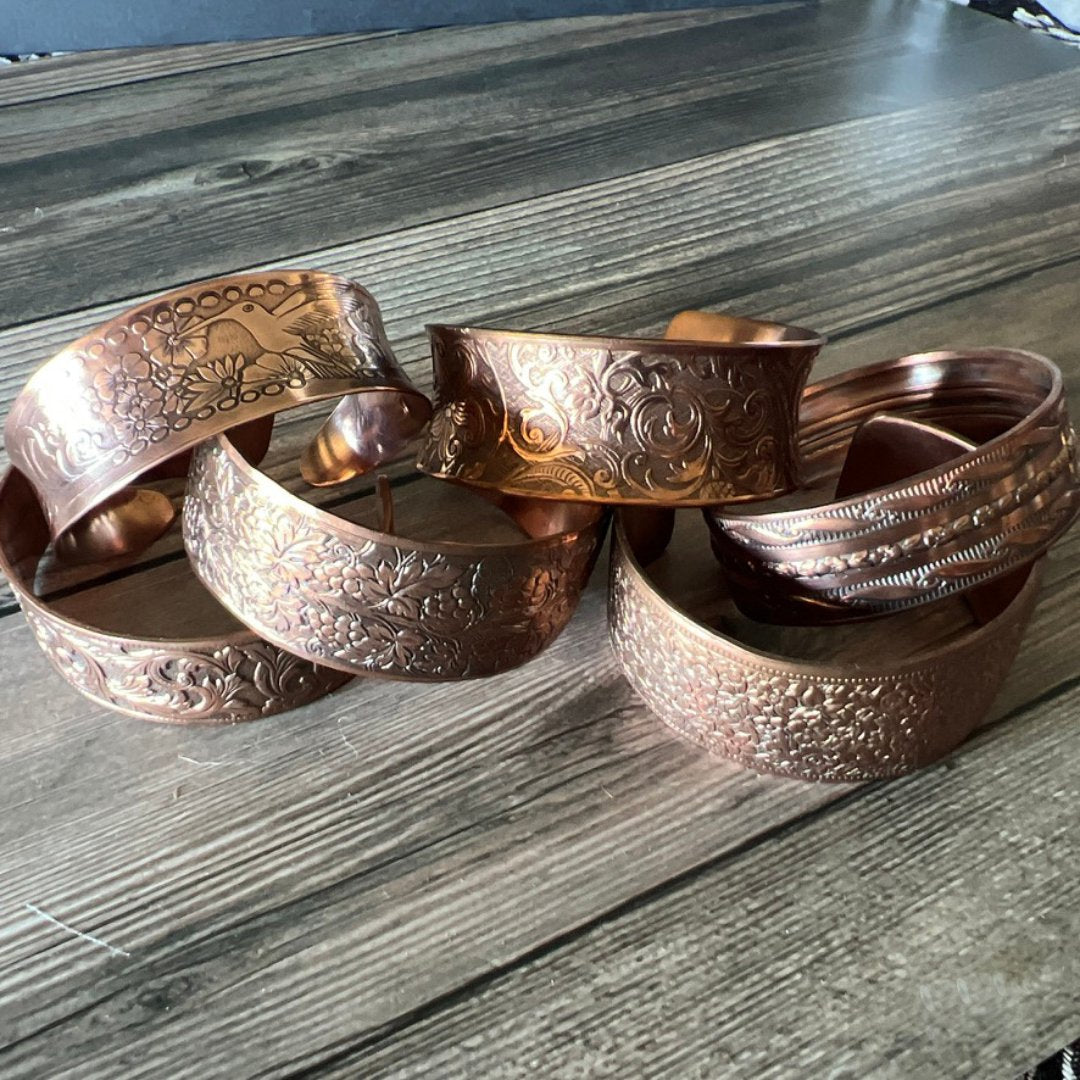 Copper Cuffs and Silver Bracelets Intricately Patterned