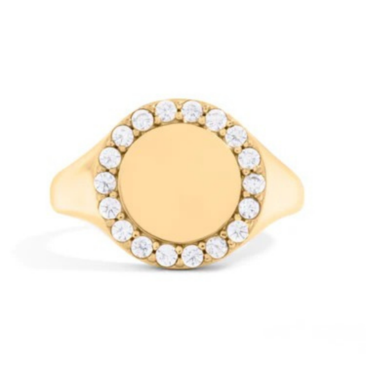 Gold ring with halo of crystals on a white background