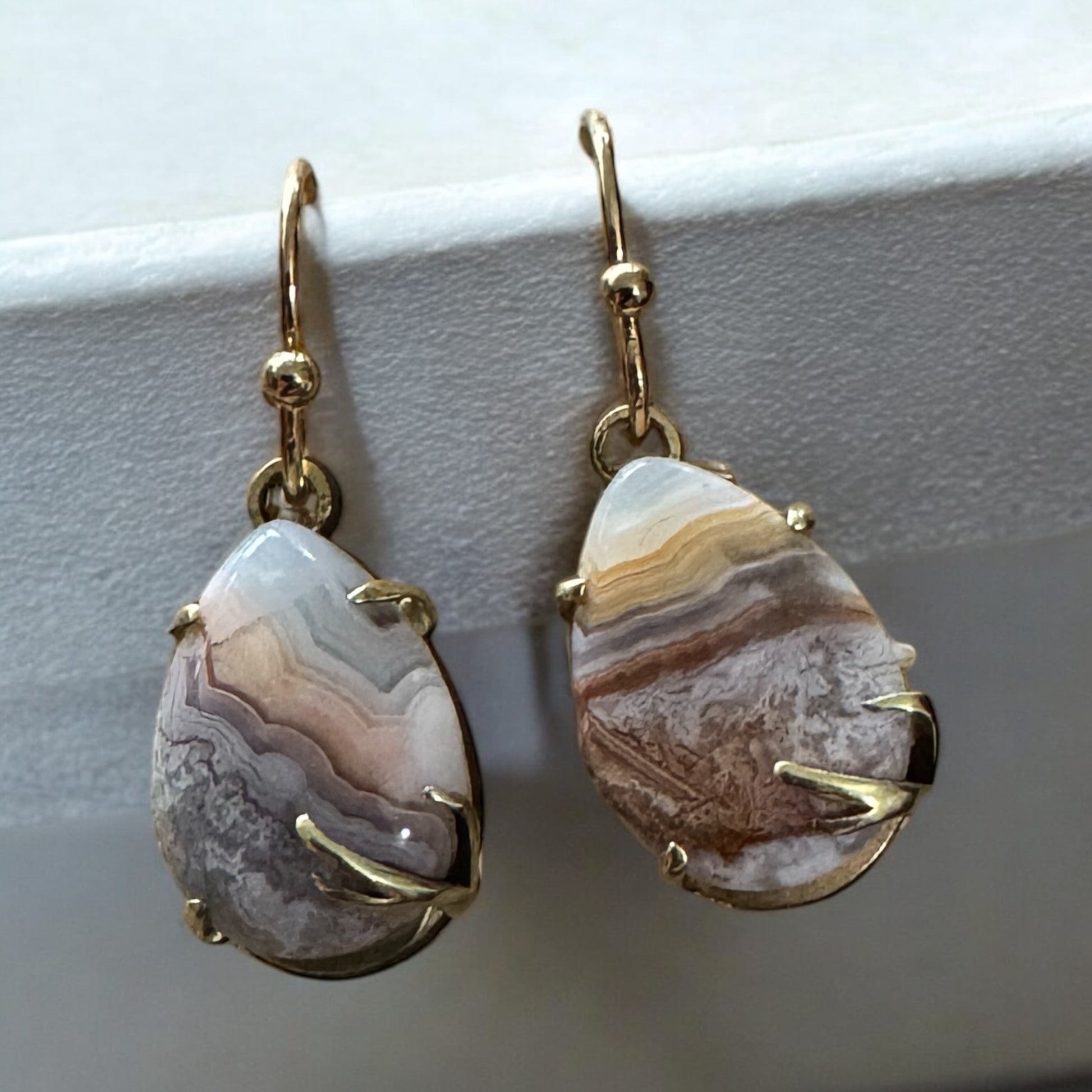 Pear-Shape, prong set crazy lace agate dangling earrings, high-polished brass