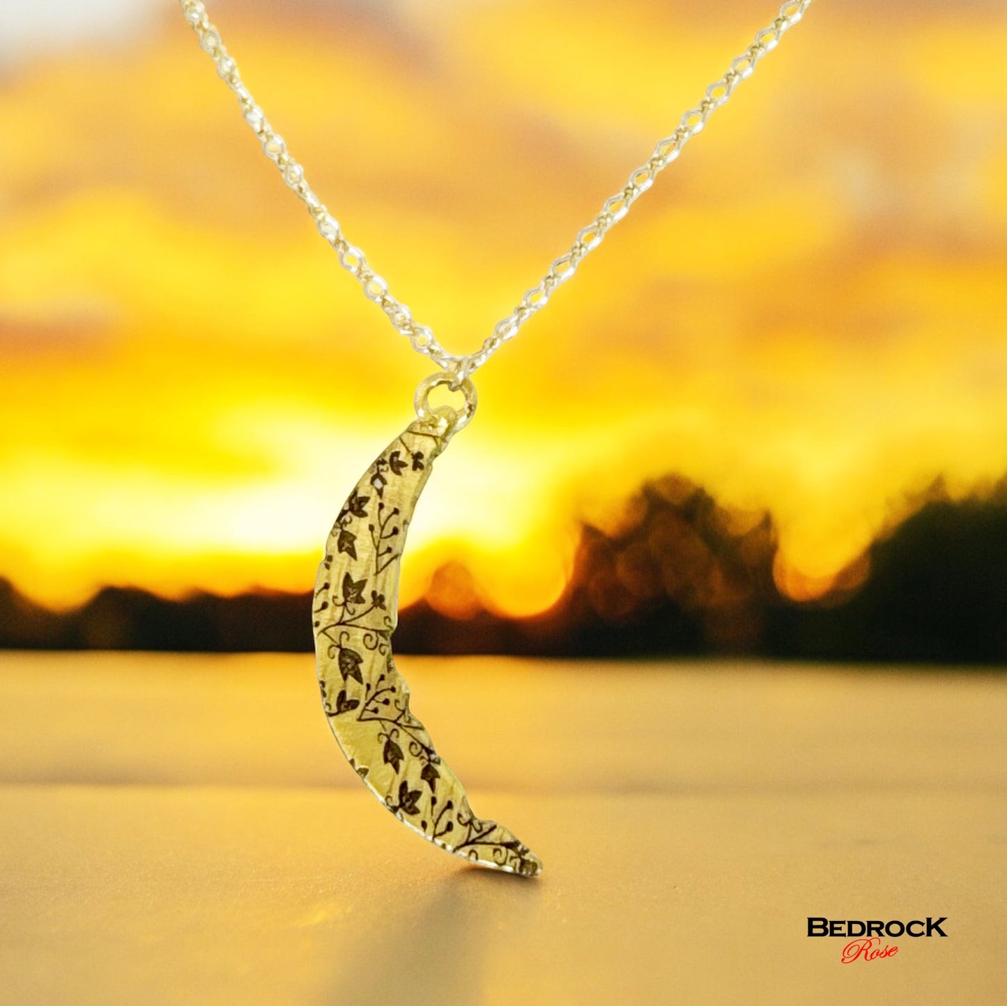 Bedrock Rose gold crescent pendant necklace with intricate vine pattern and gold fill chain.