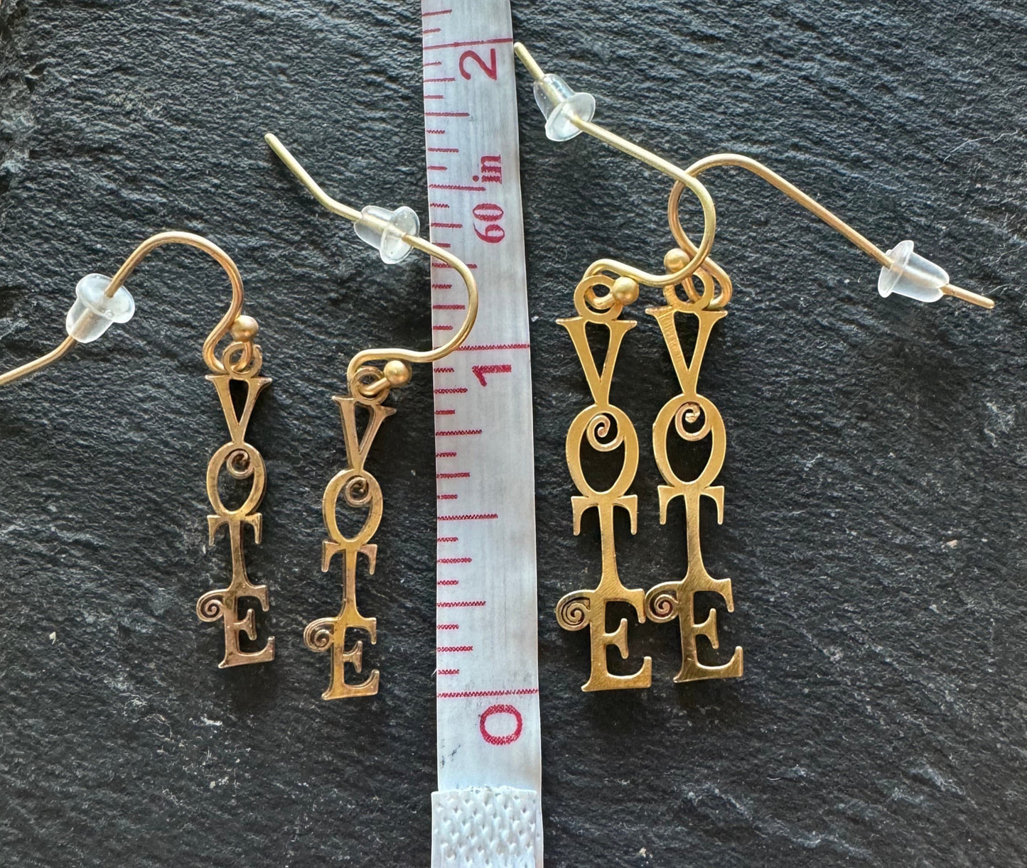 Vote Dangling Earrings Script Font next to ruler, two sizes
