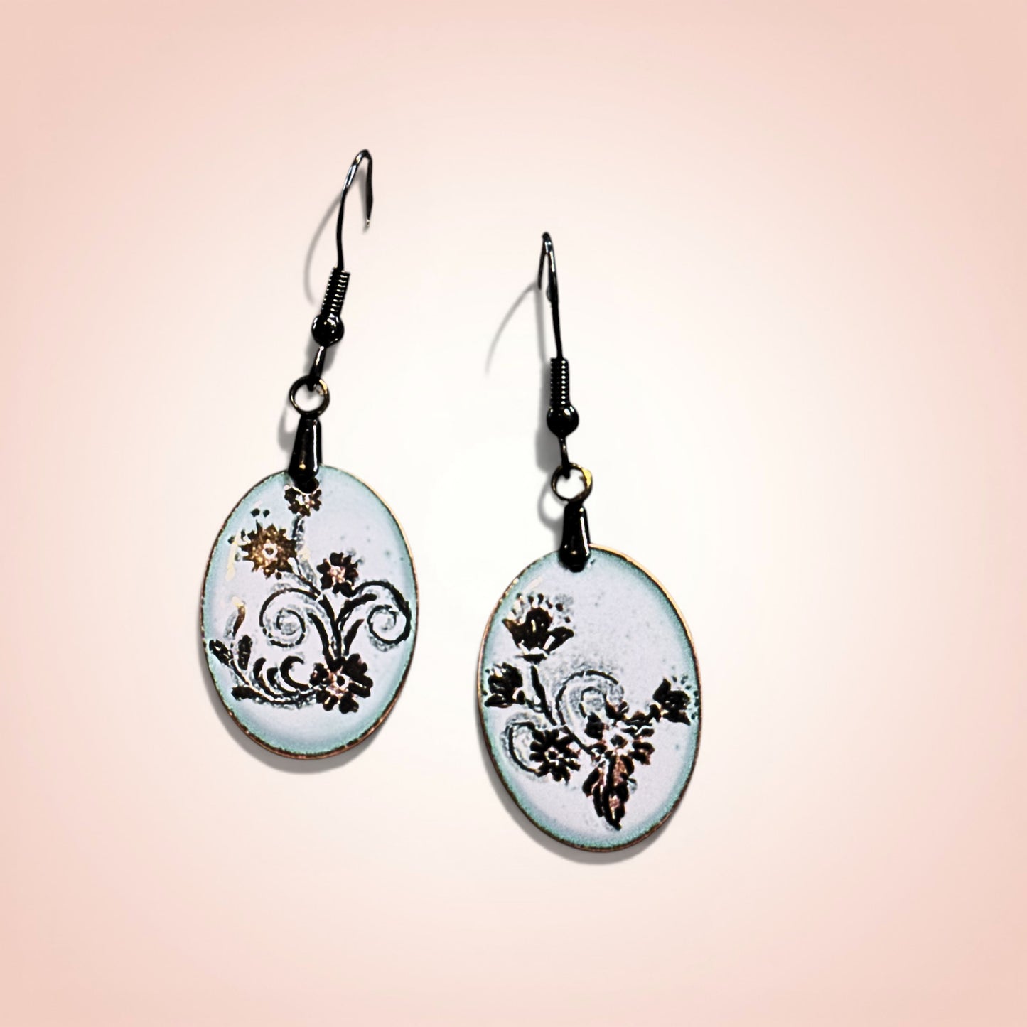 Pair of earrings with floral design on a gradient background