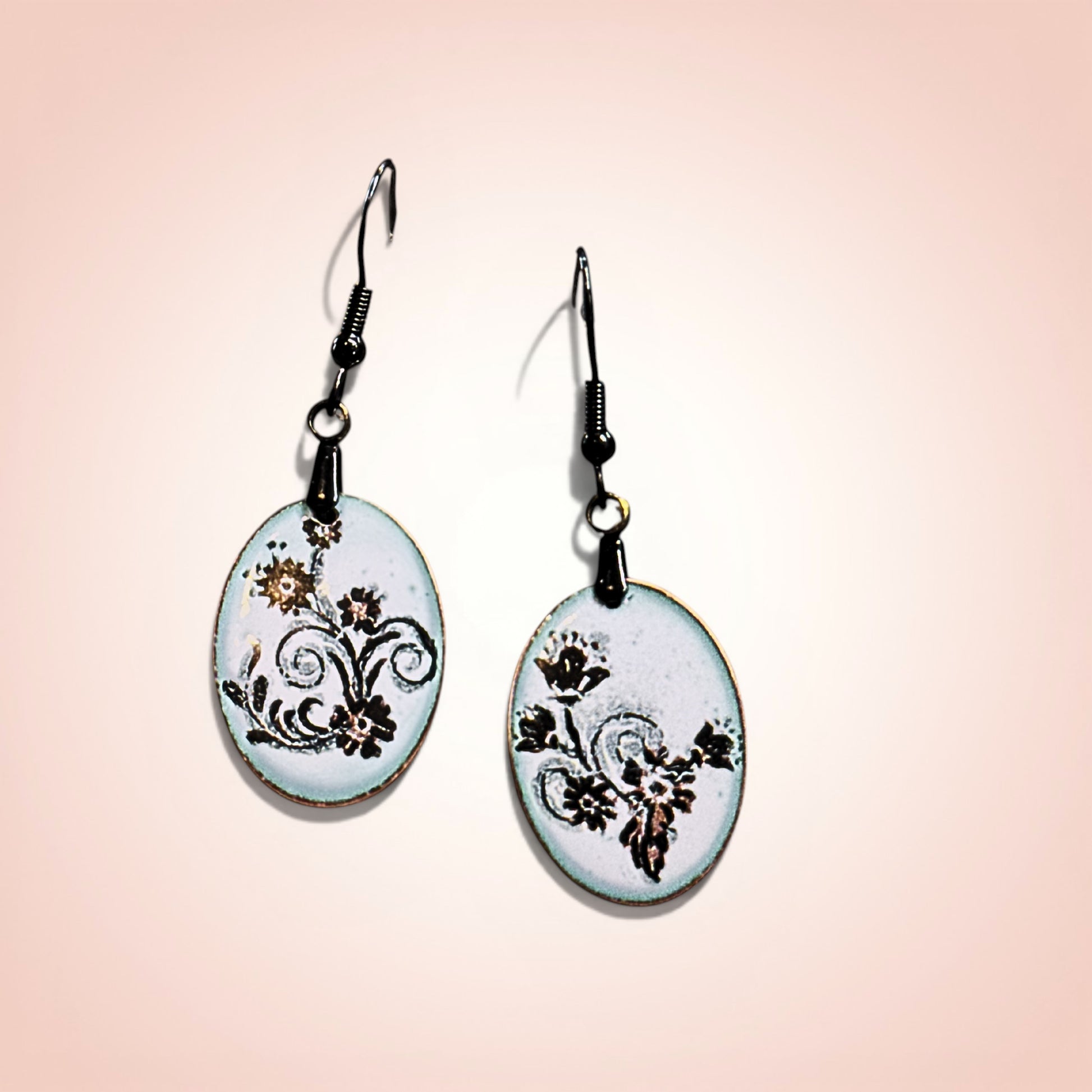 Pair of earrings with floral design on a gradient background