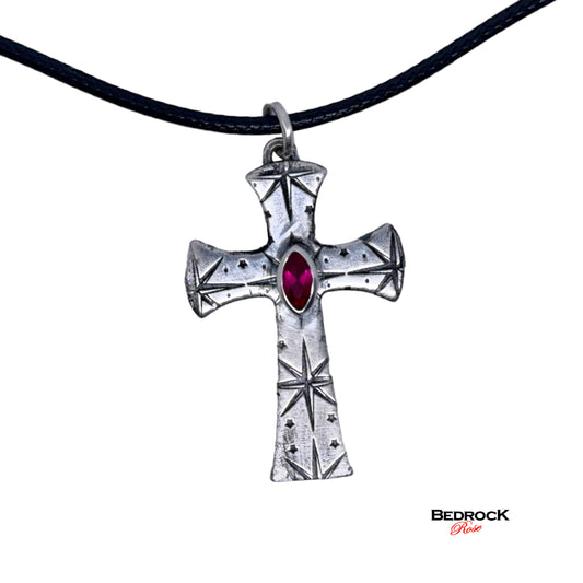 Front view of fine silver cross pendant with intricate pattern and ruby red marquise stone, Handmade necklace