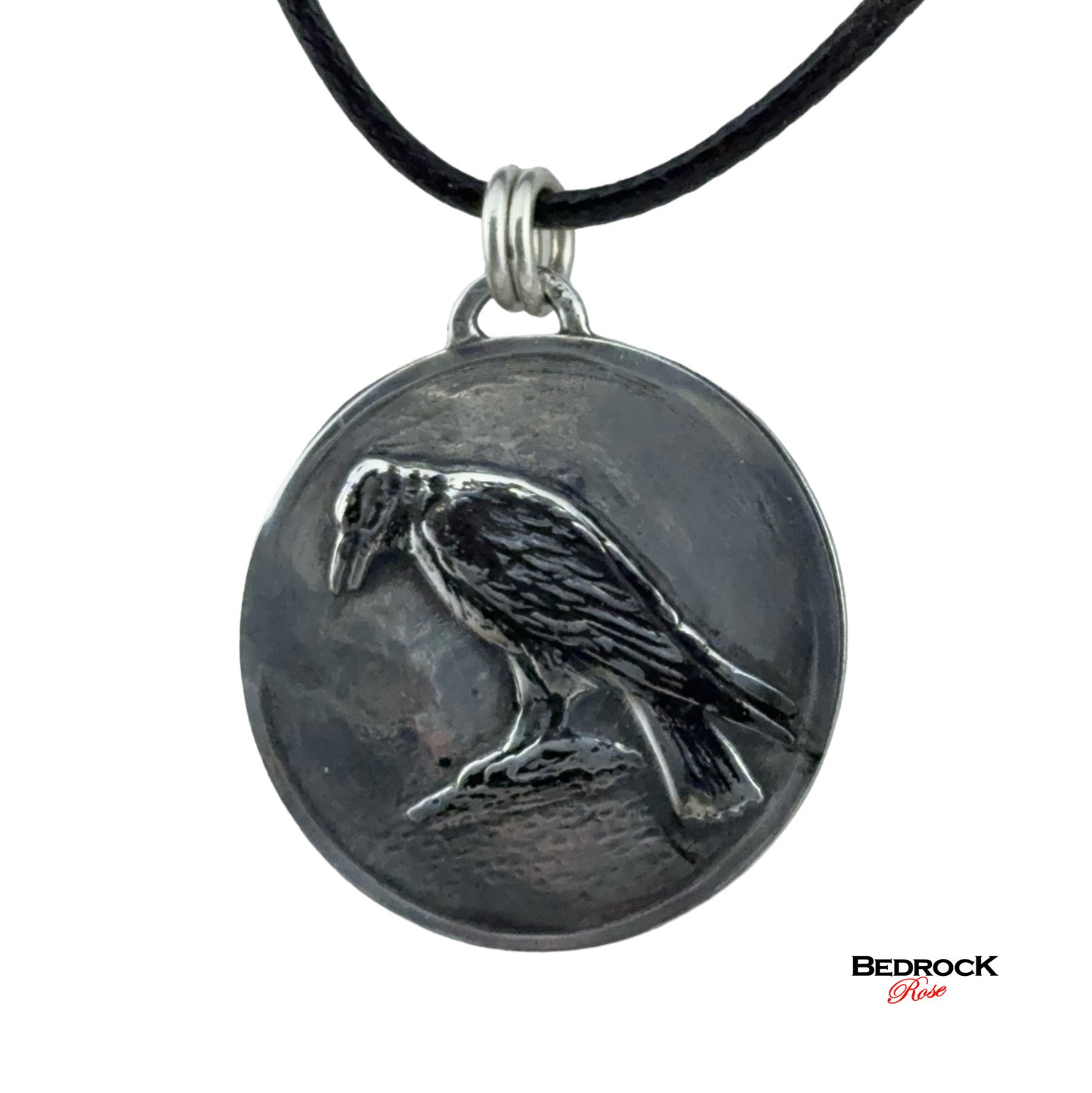 Close-up view of detailed crow design on the round silver pendant, Bird Jewelry, Handmade Necklace