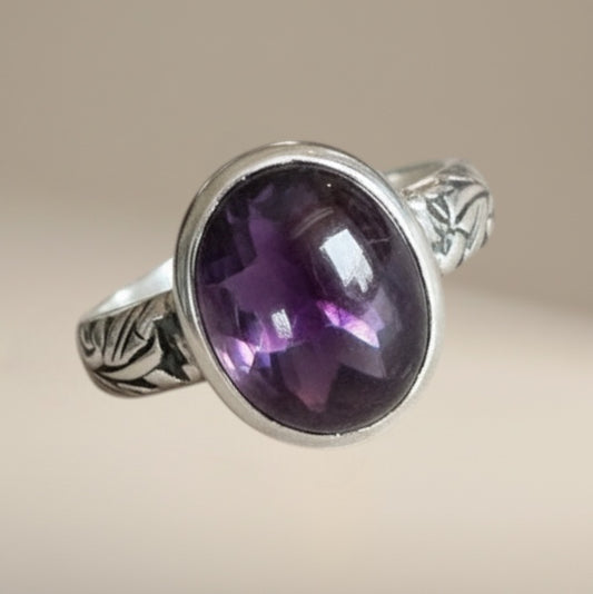 Bedrock Rose sterling silver ring with a 12mm oval amethyst cabochon and floral band design.