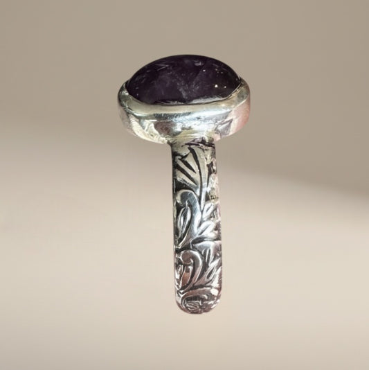 Bedrock Rose sterling silver ring with a 12mm oval amethyst cabochon and intricate floral band design.