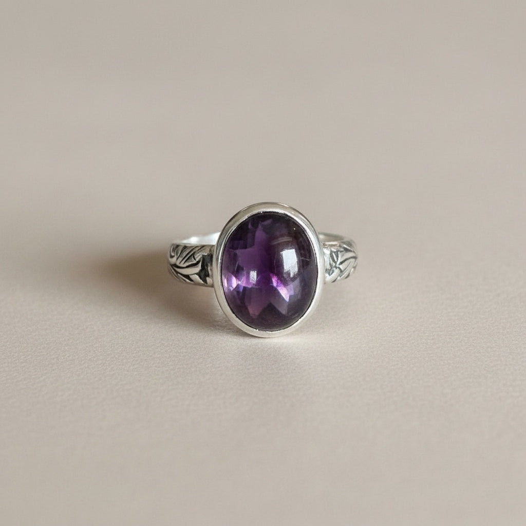 Bedrock Rose sterling silver ring with a 12mm oval amethyst cabochon and floral band design.