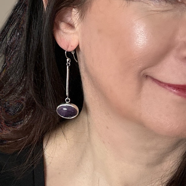 Bedrock Rose oval amethyst drop earrings in sterling silver worn on a woman's ear