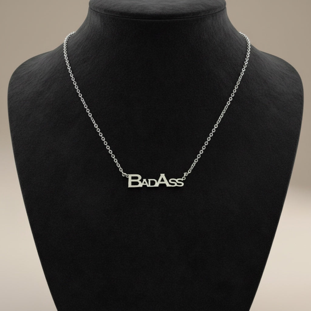 Bedrock Rose silver necklace with "Bad Ass" block letters pendant on a stainless steel chain.