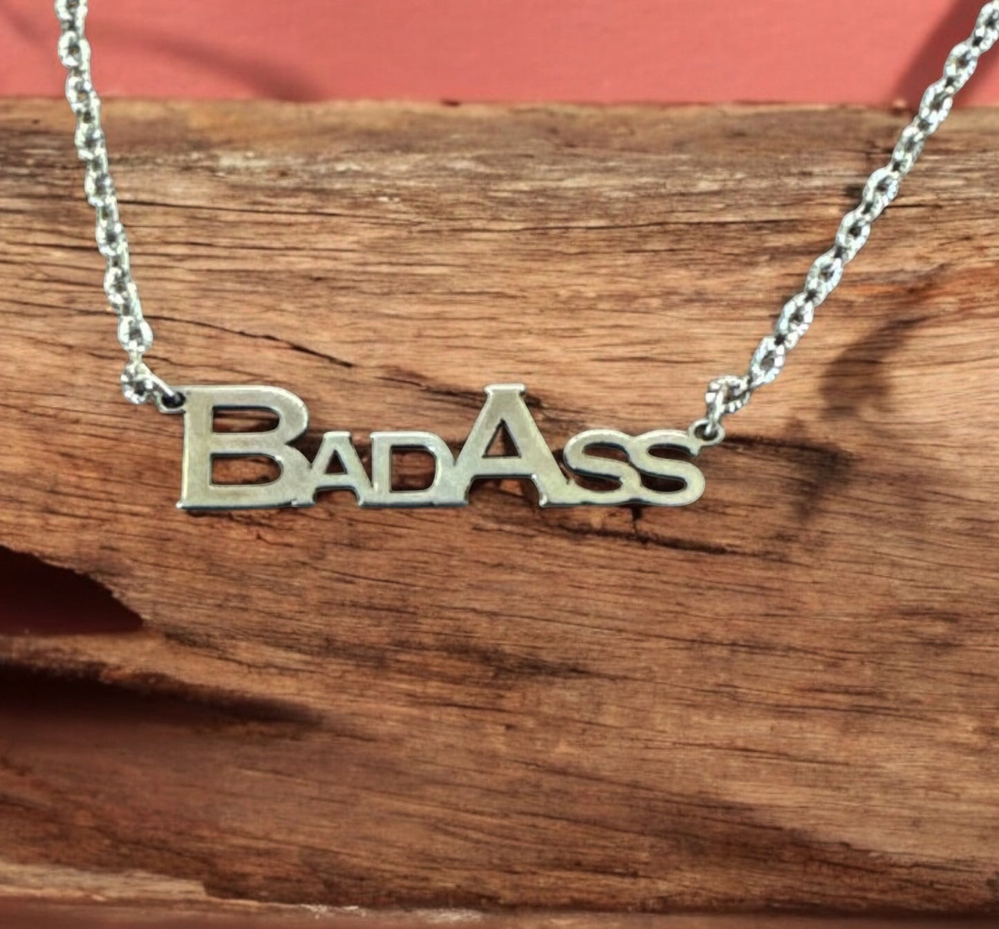 Bedrock Rose Sterling Silver Bad Ass necklace with block letters on a stainless steel chain.