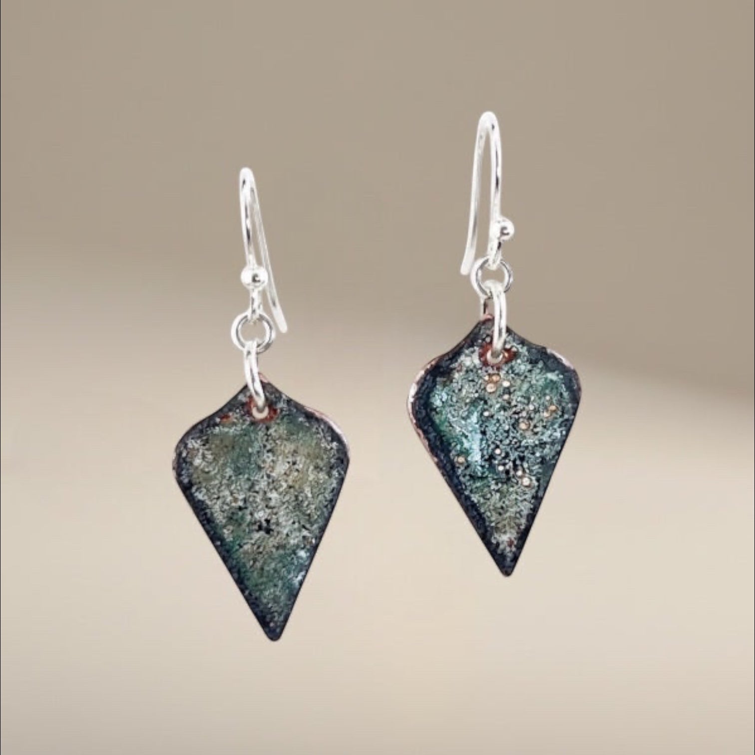 Bedrock Rose black and sparkle-effect arabesque dangling earrings with translucent enameled glass on copper and surgical steel ear wires.
