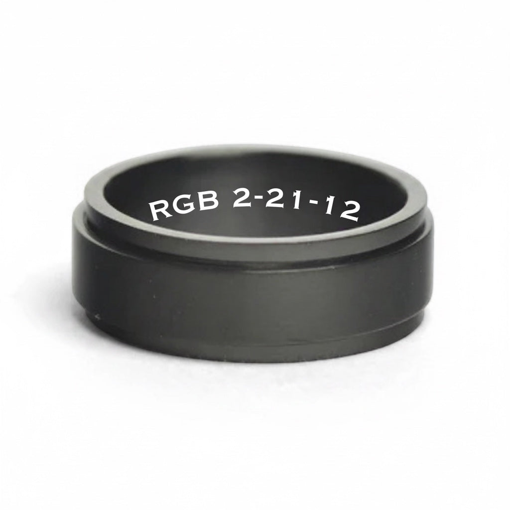 Bedrock Rose personalized black stainless steel spinner ring with custom white engraved text on the inner band.