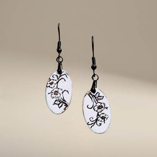 Bedrock Rose artisan black and white oval enamel dangle earrings with floral design.