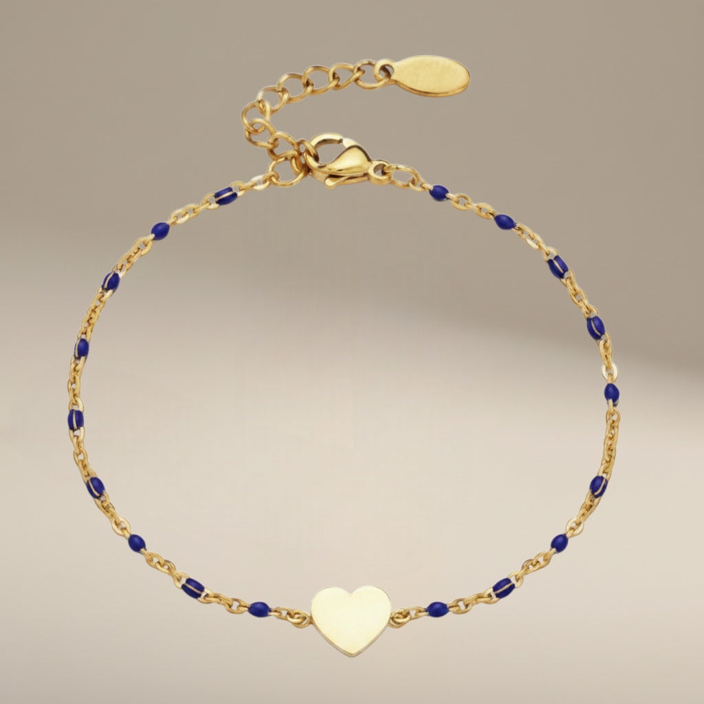 Bedrock Rose gold-tone stainless steel cable chain bracelet with blue beads and a central heart charm.