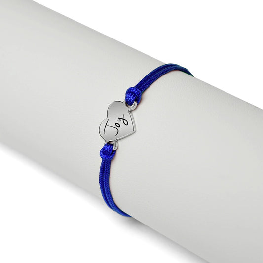 Bedrock Rose personalizable friendship bracelet with a blue cord and an engraved stainless steel heart charm