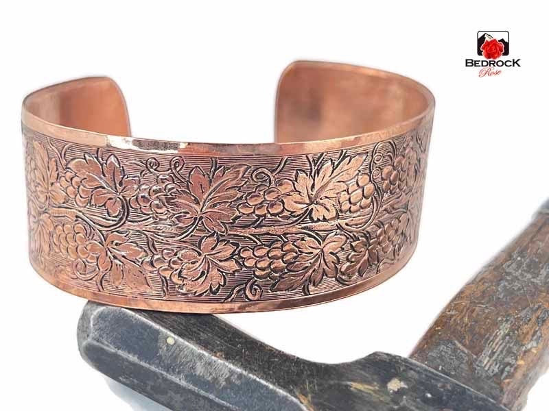 Bedrock Rose polished copper cuff bracelet featuring an intricate embossed grapevine and leaf pattern