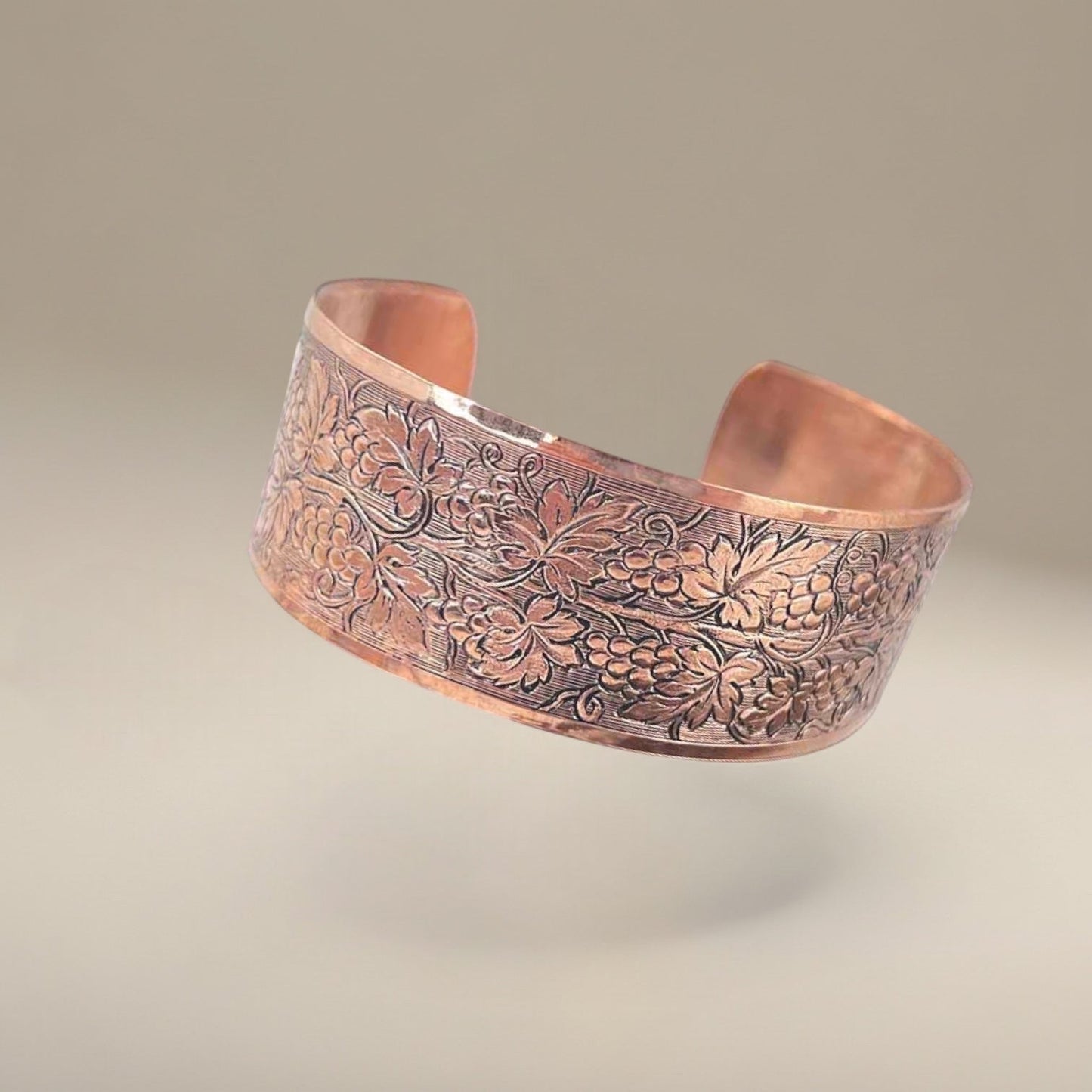 Bedrock Rose medium copper cuff bracelet featuring an ornate, polished grapevine pattern with detailed patina.