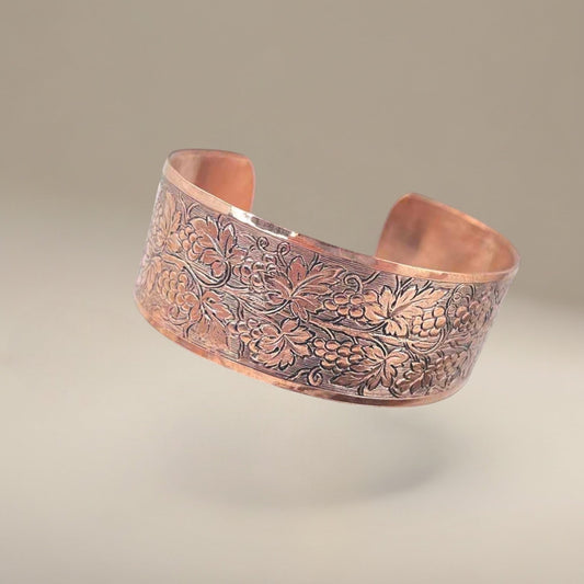 Bedrock Rose medium copper cuff bracelet featuring an ornate, polished grapevine pattern with detailed patina.