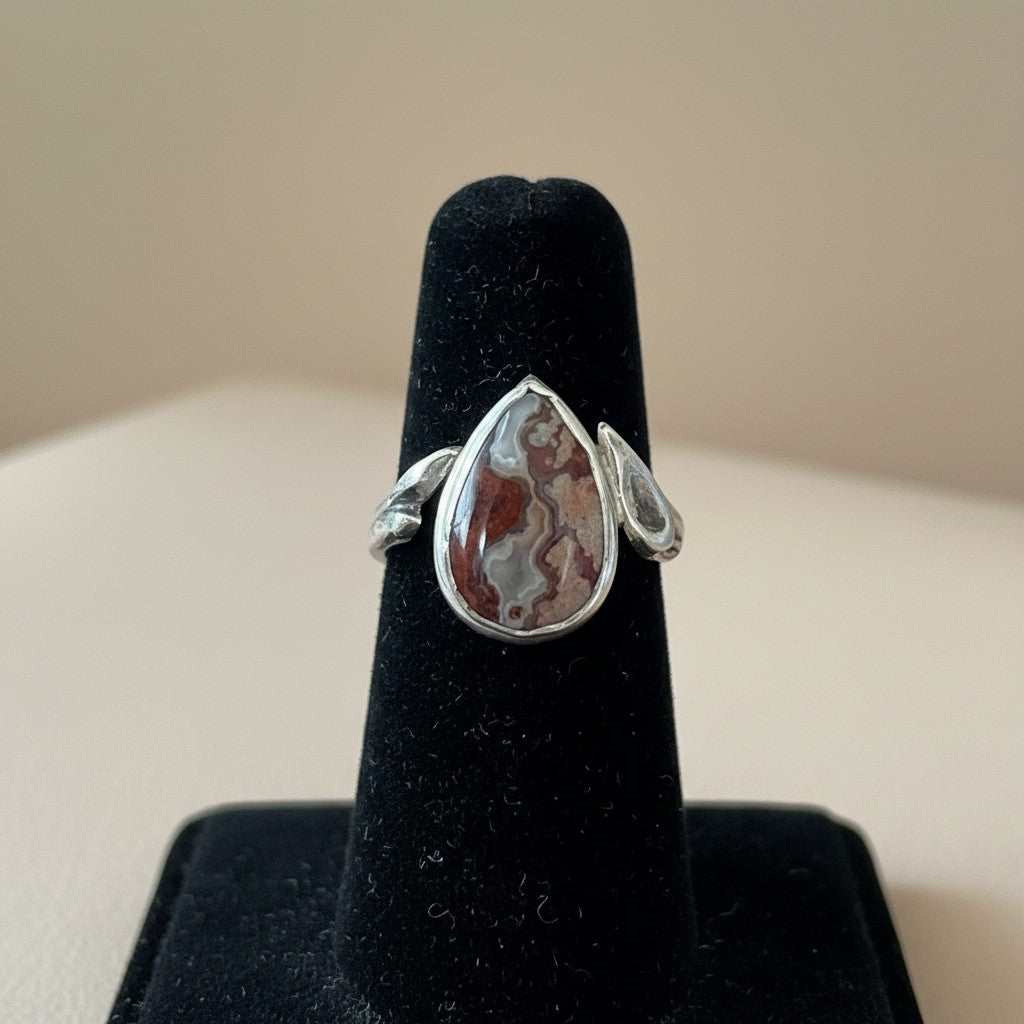 Bedrock Rose handcrafted sterling silver ring featuring a teardrop crazy lace agate stone with organic branch band.