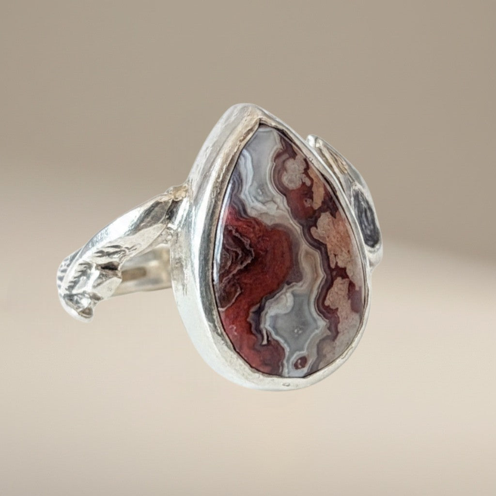 Bedrock Rose handcrafted sterling silver ring featuring a teardrop crazy lace agate stone with a branch-textured band.