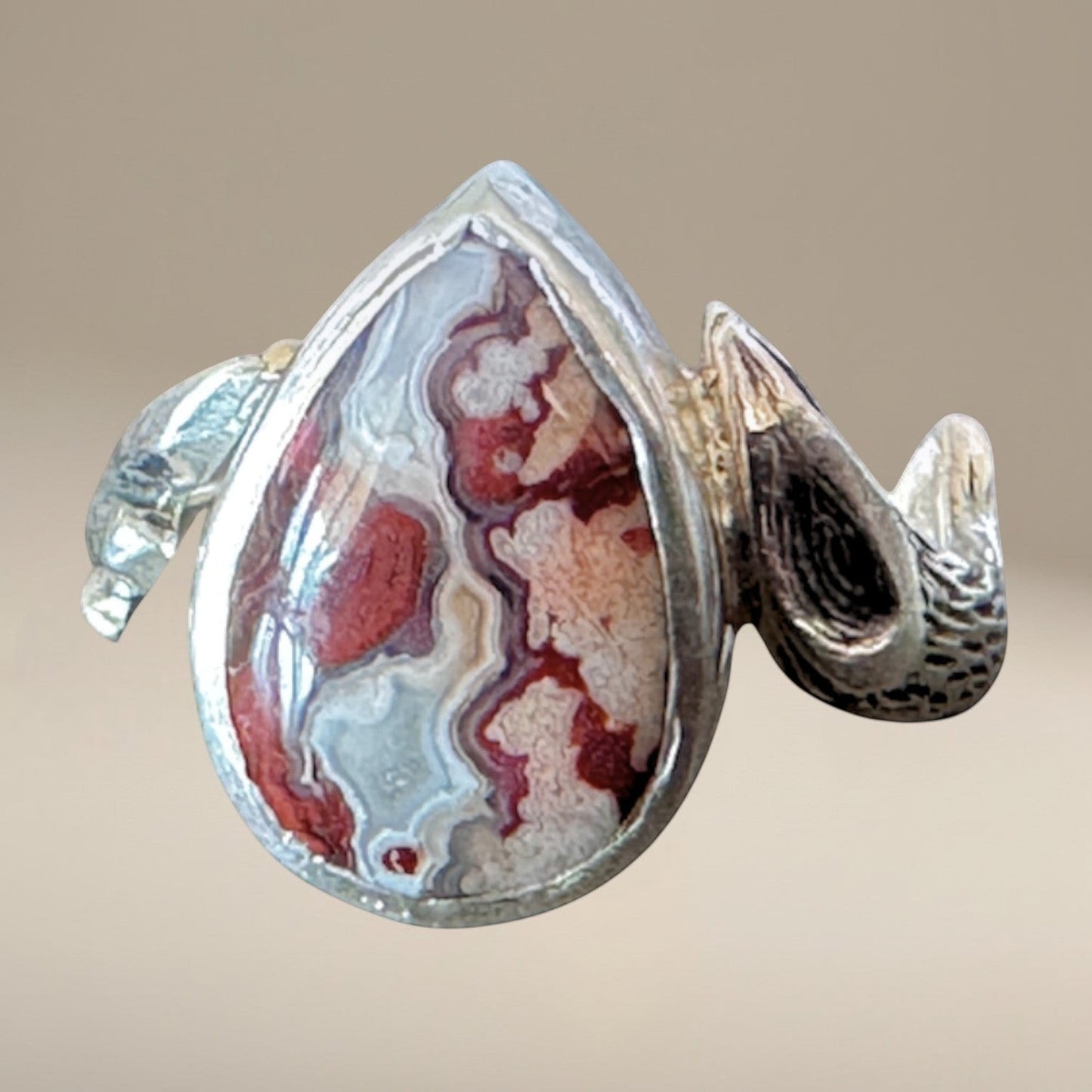 Bedrock Rose handcrafted sterling silver ring featuring a teardrop crazy lace agate stone with terracotta banding.