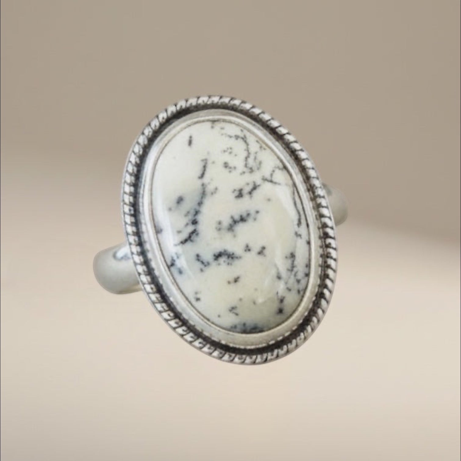 Bedrock Rose dendritic opal statement ring in sterling silver with a decorative twisted wire frame and oval stone.