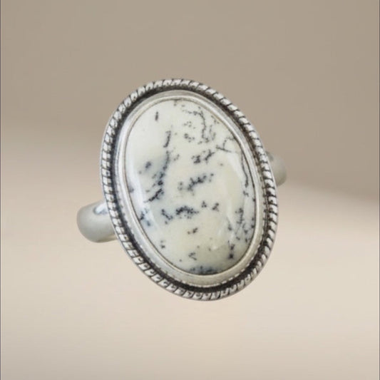 Bedrock Rose dendritic opal statement ring in sterling silver with a decorative twisted wire frame and oval stone.