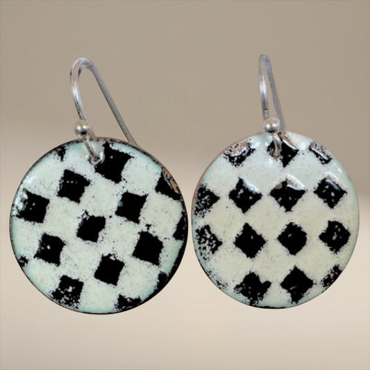 Bedrock Rose handmade round copper dangle earrings with a textured black and white kiln-fired enamel checkerboard.