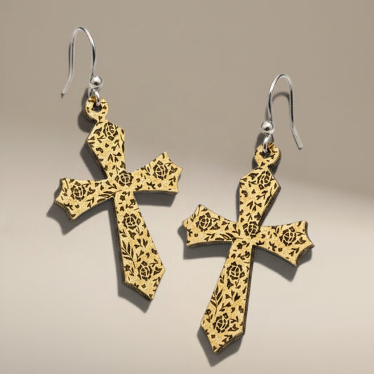 Bedrock Rose gold cross dangle earrings featuring intricate laser-etched floral rose patterns on a textured surface.
