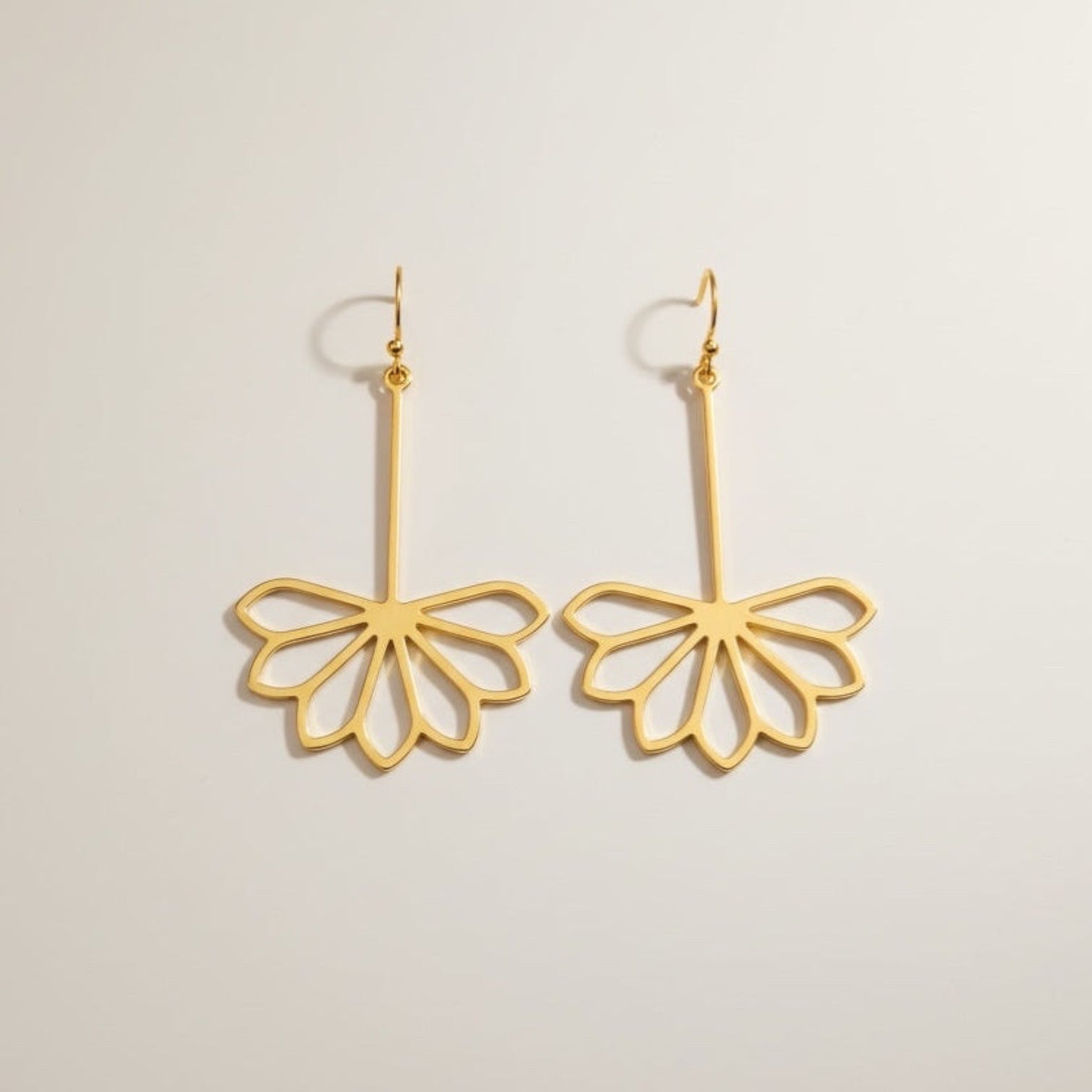 Bedrock Rose gold-plated brass drop earrings featuring a geometric Art Deco flower design on surgical steel wires.