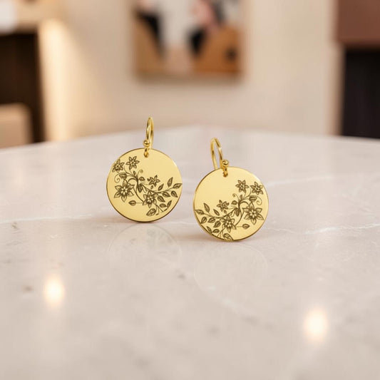 Bedrock Rose gold disc dangle earrings featuring delicate laser-engraved floral vine patterns on polished brass.