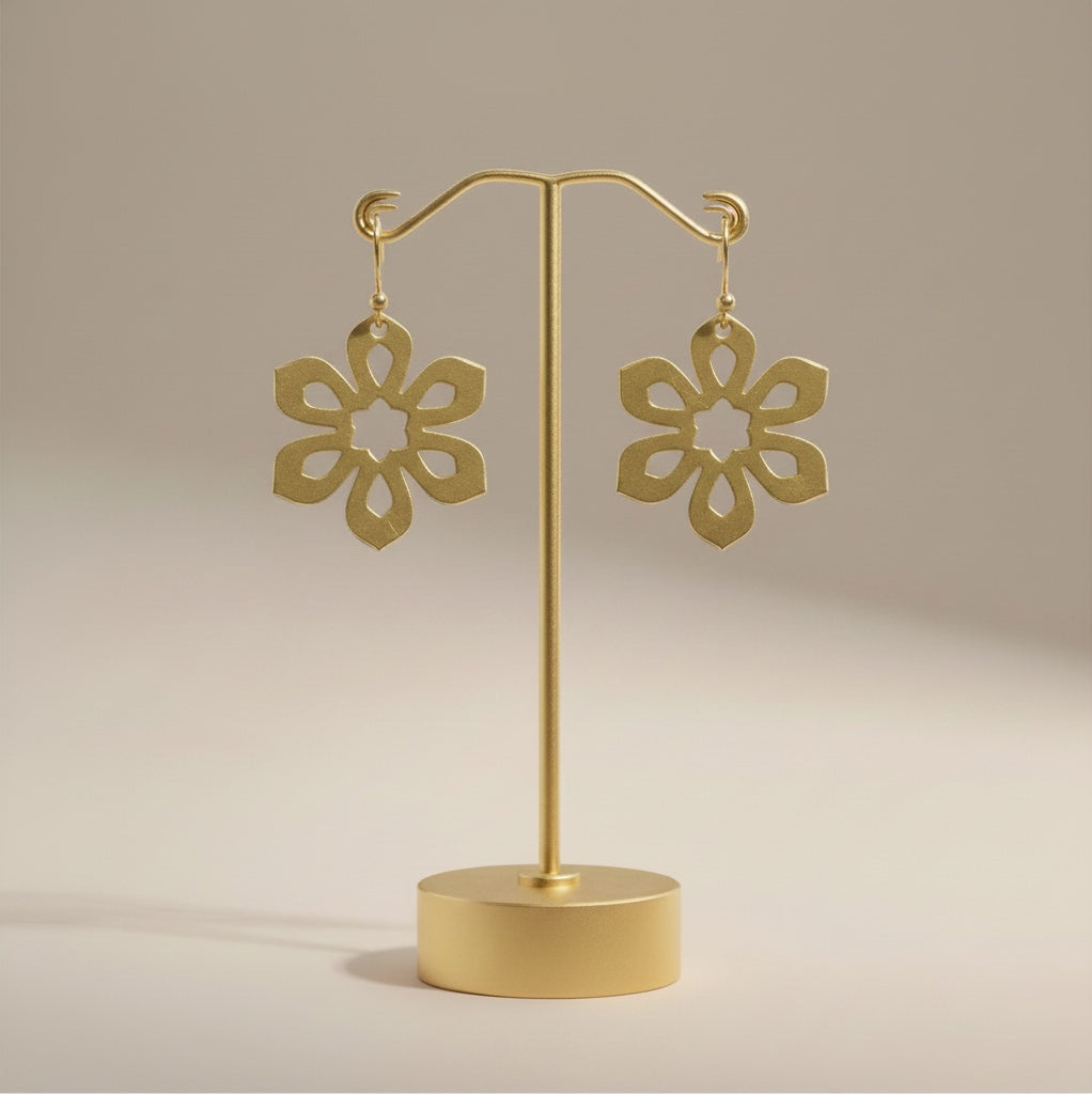 Bedrock Rose gold-plated brass Art Deco flower earrings with laser-cut floral design on a gold display stand.