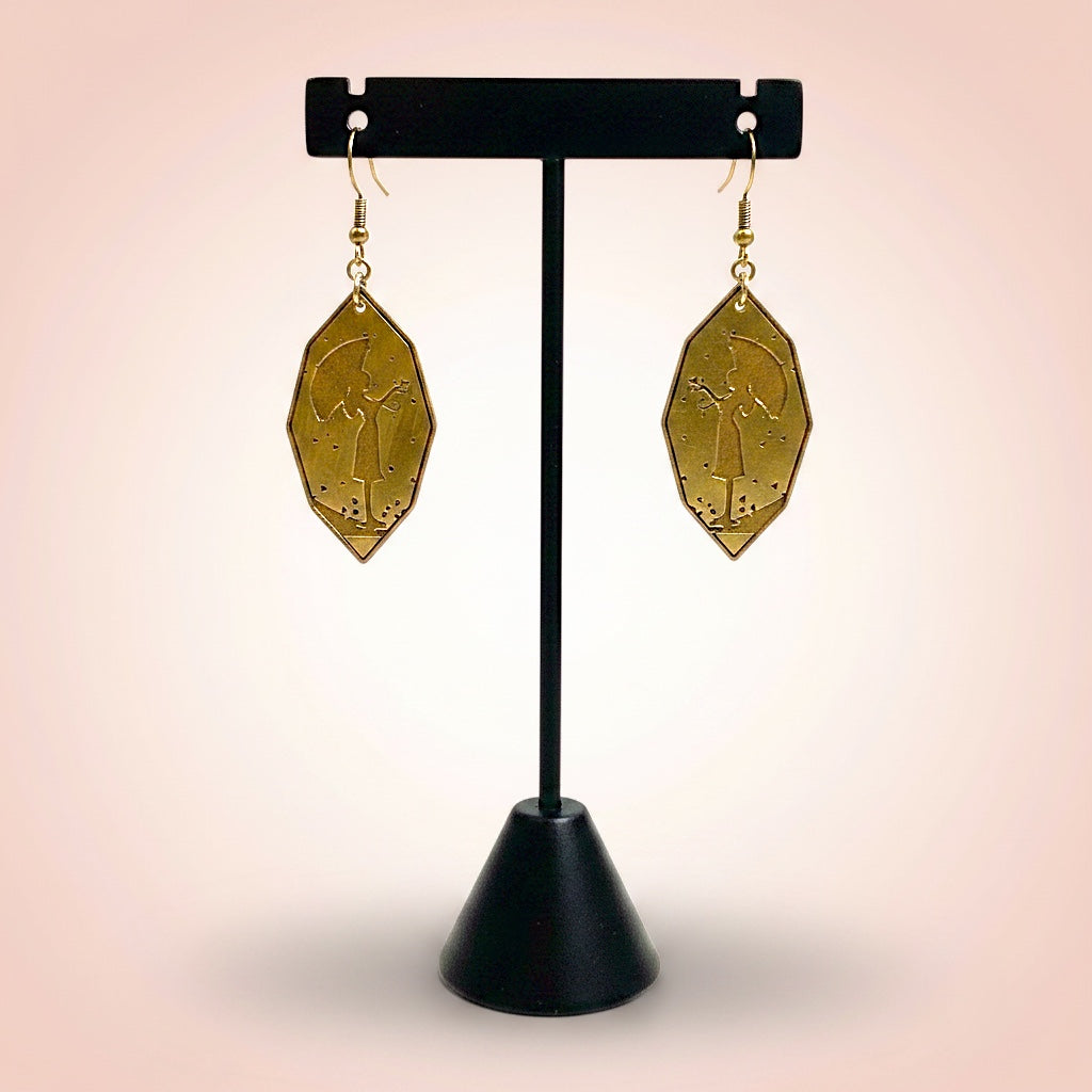 Bedrock Rose gold-tone diamond-shaped earrings featuring an etched silhouette of a girl with an umbrella and hearts.