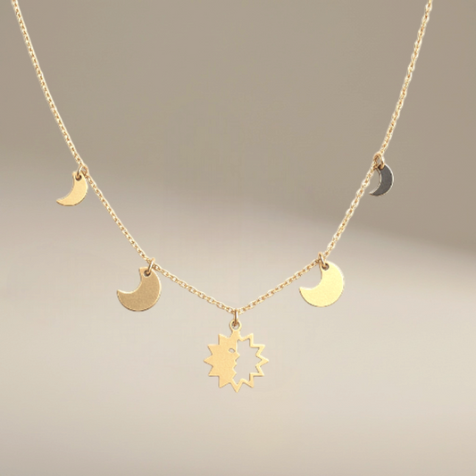 Bedrock Rose gold-fill necklace featuring a central sun charm and delicate moon phase charms on a dainty chain.