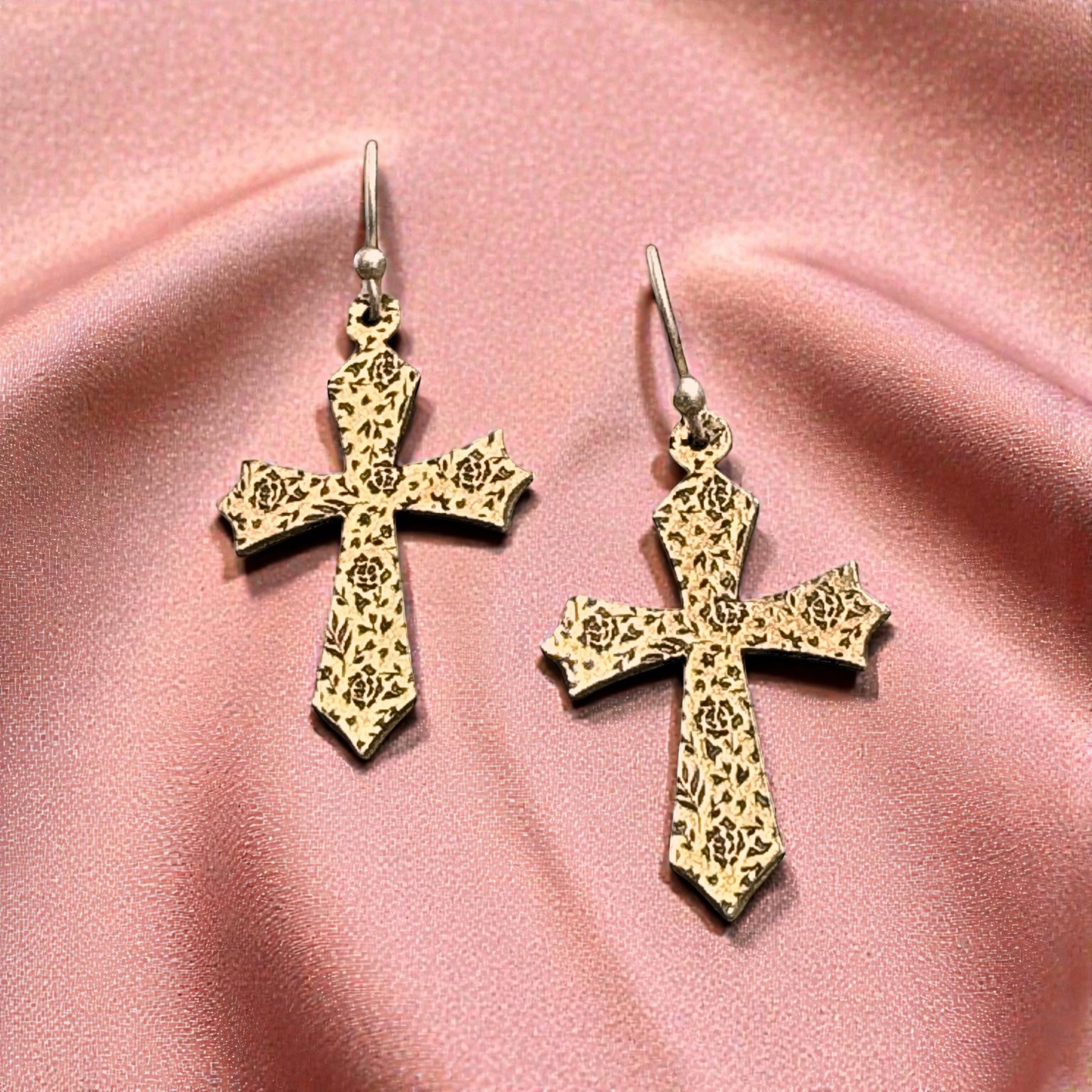 Bedrock Rose gold-tone cross earrings with intricate rose etching and hook backs.