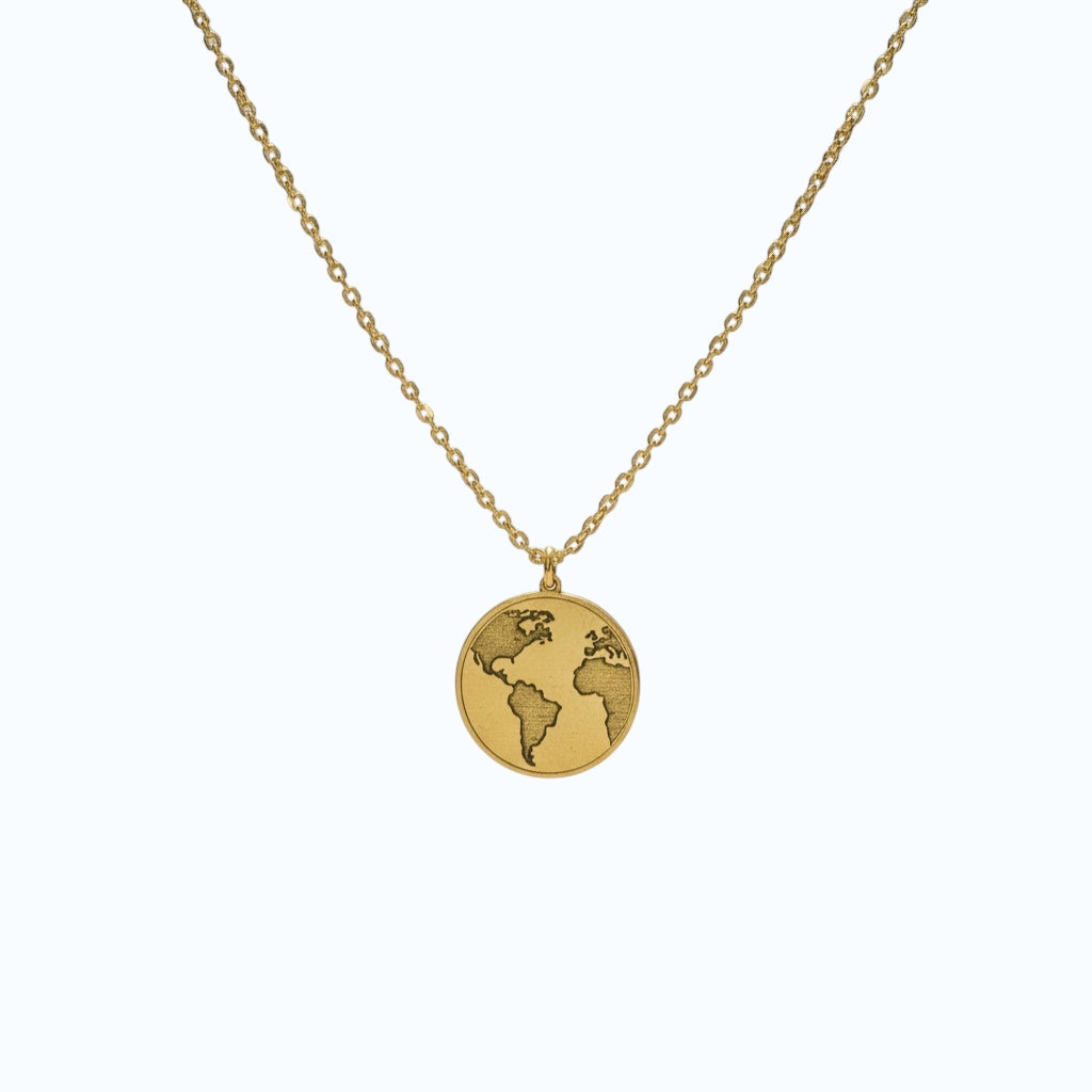 Bedrock Rose gold world pendant necklace with intricate laser engraving on a marble background.